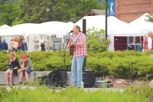 The Grand Marais Arts Festival brought throngs of people to Wisconsin Street and Harbor Park in downtown Grand Marais. A few sprinkles now and then didn’t deter visitors. Top: Part of the attraction is the talented musicians who perform during the festival, like Bump Blomberg pictured above.