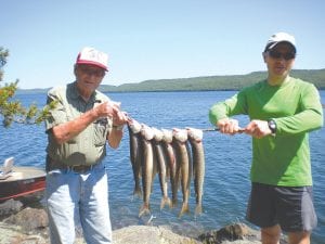 Above: Kenny Lovaas and Billy Lovaas show off their nice July 4th lake trout catch. The men were fishing with Dan Roberts of Wayzata at an area lake.