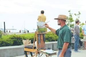 The Grand Marais Arts Festival on Saturday and Sunday, July 13 - 14, 2013 brought tents filled with works of art to Wisconsin Street in downtown Grand Marais. There were many artists offering demonstrations of their work, such as Scott Lloyd Anderson who set up his easel to paint Harbor Park—and Bump Blomberg who was providing a lovely musical score to the event. See more of the Grand Marais Arts Festival on page A3.