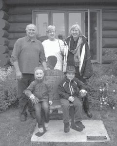 On Saturday, July 6, 2013 members of Janet Davidson Thayer’s family were on hand at the dedication of a memorial crafted by Lutsen sculptor Tom Christiansen in her memory. (L-R, standing) Sculptor Tom Christiansen; Ellie Hyatt and Marcia Hyatt, Janet Thayer’s daughters. Seated on the Grandma bench are Janet’s great-grandchildren Annaliese Raasch and Sebastian Willett.