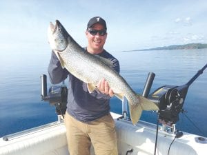 Photo by Captain Darren Peck Jake Hertel of Lester Prairie, Minnesota caught this beautiful lake trout while fishing with Tofte Charters on June 29. The trout weighed in at 12 pounds and was 32 inches long.