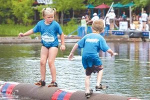 Above left: Taylor Everson (left) placed 5th in the U7 Division in the Lumberjack World Championships. Above: Jessica Berg-Collman shows the boom running form that took her to fourth in the Women’s Professional Boom Run. Left: Wellesley Howard-Larsen (middle) displays her second place plaque. Far left: Paige Everson and Dominic Wilson display their first and second place plaques