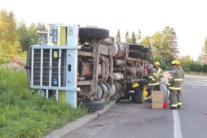 A semi-trailer hauling a load of pine logs, driven by CoLee Johnson of Hovland, overturned while making a turn onto the Gunflint Trail from Highway 61 in Grand Marais in the early hours of the morning on August 8, 2013.