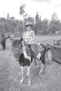 The Gunflint Horse Park was filled with horses of all shapes and sizes on Saturday, Aug. 3. Above left: Savannah Skinner rode Gypsy. Above right: Don’t spill! Riding with a cup of water tested these riders’ skills. Right: This was one of the many skill contests in the show.