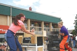 Left: Krista Braegelmann and Jessie Gallagher were all smiles as they sawed their way to first place in the Women’s Doubles cross cut log sawing competition.