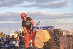 Above left: Although he didn’t win, Skyler Johnson was one of the fastest competitors in the singles saw cutting events. Above right: Competing in the final stock saw competition were Winchester Higgins and Kent Anderson (left). Anderson was the top sawyer of the night. Hedstrom Lumber Co supplied the logs used in the competition.