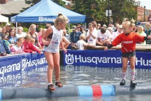 A large crowd turned out to cheer for log rollers who came from Wisconsin, Illinois and throughout Minnesota to compete in the Minnesota State Logrolling Championships held Saturday, August 3. Above: A pigtailed Libby Magnone (right) beat Taylor Everson for the U7 title. Left: Ellie Davenport, Hudson, Wis., defeated Wellesley Howard- Larsen 3 falls to 2 to take the U17 title match.