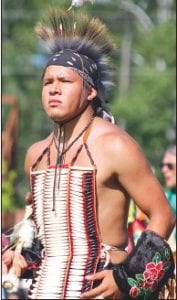 Each dancer brings his or her own style to the powwow circle, like this young man with his sturdy long-bone beaded breastplate.