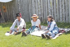 Throughout Rendezvous Days weekend, August 9-11, re-enactors talk about life in the fur trade community to visitors to the old fort. There were 123 camps around the North West Company depot this year, similar to the numbers that would have been on hand in 1797, one of the most profitable years for the company. Re-enactors could also take part in historic cooking or baking lessons, learn to sail a Mackinaw boat, try blacksmithing or finger weaving, study 18th century techniques and more. Above: This group relaxes a bit and takes in a lacrosse game on the lawn of the Great Hall.