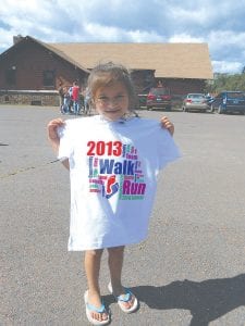 Left: Karianna Deschampe, 4, Grand Portage shows off the T-shirt earned by participants in the Grand Portage Walk – Run on Saturday, August 10. Karianna completed the one-mile walk. There was a great turnout for this year’s event that also offered a one-mile run and a three-mile walk or run on the scenic Bay Road.