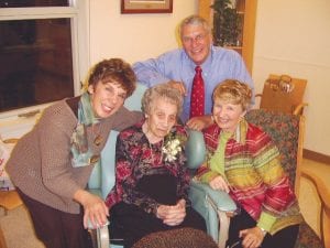 Bertha Toftey surrounded by her children at her 100th birthday party Saturday, November 22, 2008 at the Care Center: Joan Schroeder, left; Sue Hildebrand, right; and Tom Toftey, rear.