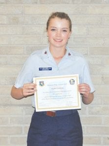 Above: Kaylee Cronberg graduated from the Civil Air Patrol Minnesota’s Wing Encampment on June 30. Left: Part of Cronberg’s training includes learning about aircraft, even taking the controls for a bit.