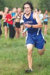 Left: Tongue out and dog tired, Viking boys' cross country captain Joey Chemlik beat his time from last year by almost a minute and placed 7th in the team’s first race of the season held on the Pincushion Trails. Above: Just an 8th grader, Kiv Hight won the junior high race and set a new record for the 1.6 mile course.