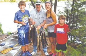 Ireland Schindel and her family enjoying time on the Gunflint Trail—and their fabulous catch of fish!