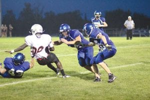 Left: Joe Borud had a good grasp of his subject matter last Friday night. The subject matter, of course being the Hinckley-Finlayson running back. Jacob Schroeder (outstretched hands) and Owen Anderson were there to make sure the runner didn’t escape Borud’s grip. Lower left: Leo Johnson put his shoulder into the tackle to slow down the ball carrier until more help arrived. Below: When Thomas Anderson, senior running back and captain went down with a season ending injury, it was up to Jack Wieben to fill his shoes at running back. Below, Wieben shows his elusiveness as he breaks a tackle for a long gain.