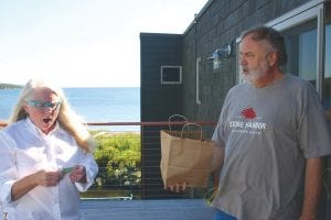 A raffle to raise funds for the upcoming Gichigami Express Sled Dog Race was held this summer with the winning tickets being drawn recently at Stone Harbor Wilderness Supply. Jack Stone of Stone Harbor holds the bag while Jan Sivertson pulls the winners’ tickets. Sivertson was astonished that one came from Skagway, Alaska. The winner of the grand prize, a stand up paddleboard, was Laura Popkes of the Gunflint Trail. The stand up paddleboard was donated by Stone Harbor Wilderness Supply store.