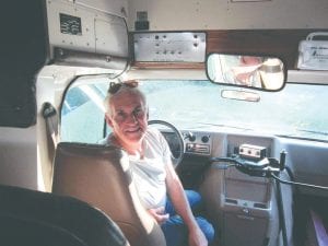 Folks who “fly” the zip line will get a ride back up the hill in a little blue bus. Superior Zipline Developer Matt Geretschlaeger is pictured here behind the wheel.