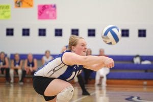 Maddy Roy (above) and Breanna Peterson show off their form digging balls off of the floor. Both players have been rock solid in the backcourt for the Vikings this season.