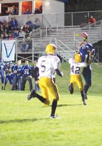 Left: Owen Anderson made a nice catch while being tackled to pick up a Viking first down. Above: Joe Borud (No. 43) and Andrew Lashinski made sure the Deer River running back didn’t go anywhere on this play. The Vikings’ defense came alive in the third quarter, holding the Warriors to virtually no yards of offense for a quarter and a half.