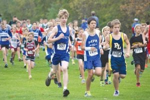 Top: Wearing bib No. 593, Viking cross country runner Finn Gerry, an eighth-grader, ran 2 minutes faster than he did last year at Milaca, finishing the 2-mile race in 13:38. Left: Sean MacDonell (No. 597) and Jake Peron (No. 598) were the Vikings’ third and fourth runners at Milaca, helping the boys’ team to a 14th place finish out of 27 teams. Above: Running strong, Alyssa Martinson finished the 4k varsity race in 18:06 at Milaca.