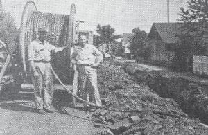 Modern-day crews are busy plowing in fiber optic cable for Internet service. But 52 years ago, the focus was on getting phone lines to Cook County residents. This picture from August 31, 1961 is captioned: Rudy Backlund, left, of C.O. Backlund & Sons and Paul Larson, local manager of the Northwester Bell Telephone Co., watch as the first of 280,000 feet of telephone cable is being buried here. The cable will reach from Grand Marais to Baptism River where it will connect with existing cable, Larson stated. It will handle long distance calls from here, he said. The News-Herald noted that the cable reels were seven feet high and carried 2,800 feet of cable each. The caption said the “plowing under” of the cable along the shoulders of Highway 61 would begin after Labor Day.