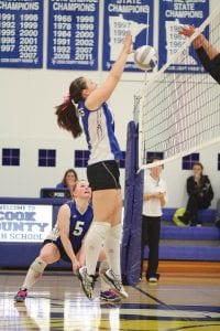 Left: Note the look on No. 5 Anna Carman’s face as Megan Lehto blocks a Barnum spike. Only Lazarus made a bigger comeback than the Vikings did in their third game against Barnum in a match filled with more ups and downs than a roller coaster ride. Top: Carrie Palmer takes a knee to dig the ball off of the floor. Above: Jessica Berg-Collman is down on both knees digging the ball from the floor against Barnum.