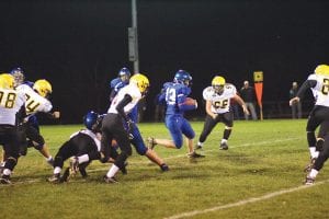 Left: Joe Borud found some running room against the Eveleth- Gilbert Golden Bears in the Vikings Homecoming game. Above: Jack Wieben ran for a first down on this play. Wieben scored the Vikings’ lone touchdown in the 41-6 loss to the Golden Bears.