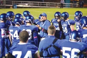 With the players listening intently, Assistant Coach Bryan Carpenter gave instructions to the football team at a recent home game. The Vikings have had a hard season, losing many players to injuries.