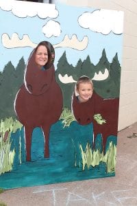 Top: The new Moose cutout at the Grand Marais Information Center (Moose Central) was a hit with visitors. Above right: Murray the Moose made friends all over town! Lower right: Stone Harbor Wilderness Supply staffers got in the Moose Madness spirit with their eclectic antlers.