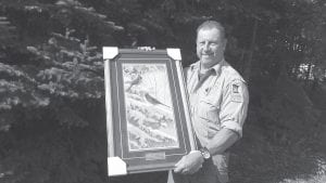 Eric Nelms of Hovland was presented with an award for 30 years as a volunteer snowmobile safety instructor for the DNR. Nelms has also been a firearms safety instructor for over 10 years and an ATV safety instructor for almost 10. The award is a lovely commemorative print of cardinals in snow.