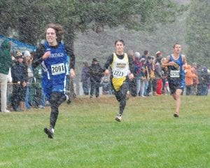 Above: Gritting his teeth and sprinting hard for the finish, Joey Chmelik (2091) broke 18 minutes for the 5k and qualified for the state meet with his 16th place finish. Left: Audrey Summer (2145) ran the race of her life in the Section 7A final, but just missed qualifying for state by 7 seconds. Above left: Wearing bib 2147, Morgan Weyrens- Welch improved her time by two minutes from her last race at the Section meet.