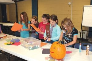 Above: Cook County was abuzz with Halloween activities last week. The 3rd and 4th grade Girl Scouts—Troops 4109 and 4070—had a good time decorating pumpkins and making matching fall placemats. Of course some Halloween candy was also enjoyed!