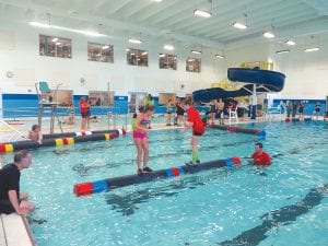 Logrolling action was fast and furious at the Hudson YMCA on Saturday, November 2 where three members of the North Shore Rollers participated in the national amateur logrolling tournament. Above: Paige Everson (left) beat this competitor to move on and eventually roll for the national U10 title. Left: Wearing her “Restore to Roar” T-shirt, Wellesley Howard-Larsen lost this match to Libby Papadopoulos but later beat Katelyn Potts who beat Libby for the national title.