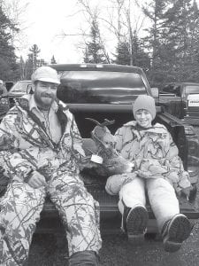 Nick Danielson, 12, from South Haven, Minn., got his first deer on opening day of rifle deer season on Saturday, Nov. 9, 2013. Nick (right) got an eight-point, 190-pound buck while hunting with his uncle Chad Smith of Grand Marais.