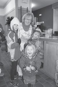 Above: It’s become an annual family tradition for these young ladies to visit Mrs. Claus (Leona Sherer) at the Cross River Heritage Center holiday celebration.