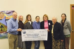 The people working to establish the BackPack Program in Cook County schools were happy to accept a donation of $3,000 toward the program from the North Shore Federal Credit Union (NSFCU) on Tuesday, November 19. (L-R) NSFCU President Mark Summers, Commissioner and School Wellness Committee member Heidi Doo-Kirk, School Nurse Kay Borud, Cook County Extension Director Diane Booth, ISD 166 Pre-K-5th grade Principal Gwen Carman, NSFCU Community Outreach Coordinator Carol Youngberg and State Health Improvement Program (SHIP) Coordinator Kristen Wharton.