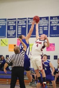 Left: Tipping off the baskeball season, Jonny Jacobsen (40) went up high against the center from Nashwauk. Above: Jamie Wick had nice touch on his 3-point shots but the ball often just rimmed out. The Vikings played a good game but lost 48-36 to the Spartans.