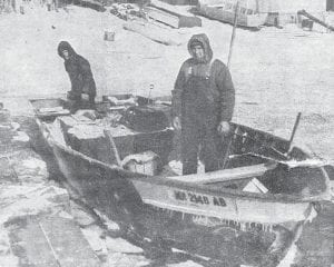 A well-iced skiff, two heavily clothed fishermen, and icy surroundings give some hint of the rigors of commercial fishing on Lake Superior in the dead of winter. Tom Eckel, left, and his brother Dick were ready to push off from their Grand Marais harbor dock in this undated photo from the News- Herald archives. The steel-hulled boat could push through 3-4 inches of ice: the 75-hp outboard pushed the bow up on the edge of the ice and the weight of the boat crushed it. If the ice wasn’t as thick, the boat could plow right through.