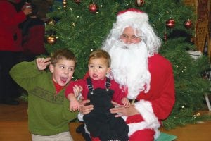 After the Cook County Chamber Christmas Parade on Friday, November 29, kids of all ages got to visit with Santa Claus and his sled dogs at Stone Harbor Wilderness Supply. Little Rio had fun trying to get his brother Nico to smile while sitting with Santa.