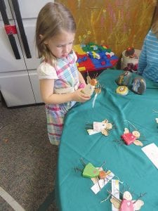 Once again the weekend was filled with fun holiday events. This little girl checks out the crafts—adorable wooden angels—at the Free Church Christmas Craft Sale.