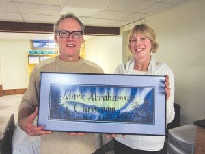 Longtime nursing instructor at Cook County Higher Education, Mark Abrahamson, was recognized on Saturday, December 7 when the nursing lab classroom was named in his honor. Abrahamson is pictured here with Cook County Higher Education Director Paula Sundet Wolf and the lovely classroom sign painted by Steve Byers.