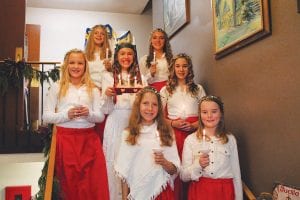 Bringing light to the darkest day of winter were St. Lucia and her täntor (attendants). The young ladies brought the Scandinavian tradition of St. Lucia to life at the 2013 Julefest at Bethlehem Lutheran Church on Saturday, December 14. (L-R, front) Elsa Lunde, Amelia Roth. (L-R, middle) Sophie Eliasen, St. Lucia Linnea Gesch, Claire LaVigne. (L-R, back) Sela Backstrom, Reilly Wahlers. See more about the Julefest celebration on page B3.