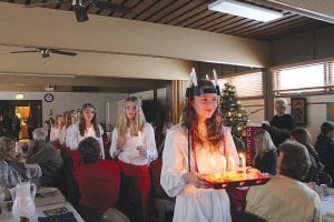 Julefest at Bethlehem Lutheran Church on Saturday, December 14 was brightened by the appearance of St. Lucia (Linnea Gesch) and her täntor who brought in candles and saffron buns, sweetly singing the St. Lucia song.