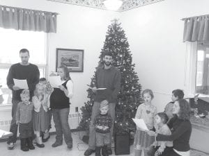 There were a lot of visitors and Santa’s helpers at the North Shore Care Center over the Christmas season. Above: The Brook and John Henneman family and the Renee and Joel Pike family lead caroling songs on Christmas morning at the Care Center. Left: Mrs. Claus (aka Marie Jacobson) surrounded by her family, Larry and Elaine Dean and sons Tyler (left) and Bryan.