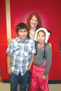 Above: Last summer, Janicek worked with Grand Portage youth to create numerous works of art. (L-R) Angel Burnett, Belle Janicek, and Rhonnie Poyieier. Left: This painting by Niimin LeGarde was one of the works of art. A description of her work stated, “Niimin LeGarde likes mixing colors. She says, ‘I like making art because if you don’t like something you can always change it!’”