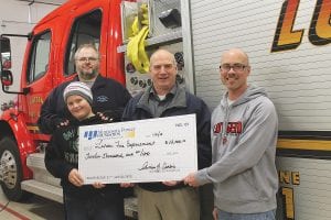 On Friday, January 3, representatives of the Minnesota Power Foundation presented a grant of $12,000 to be used toward a new fire support trailer for the community. Joe Frederickson, a fuels technician at the Minnesota Power Taconite Harbor Energy Center (left) and his son Zack with Taconite Harbor Managing Superintendent Dave Rannetsberger presented the grant to Lutsen Fire Chief Paul Goettl. Frederickson is the worker who was seriously injured in a coal dust explosion at Taconite Harbor in October 2012. He has returned to light-duty work at Taconite Harbor for a few hours each week and was happy to be part of the presentation supporting local fire departments.