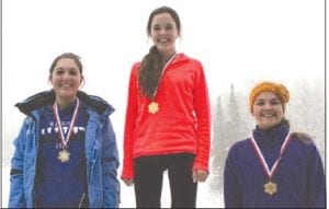 Left: Junior varsity racers Santina McMillan who took 1st (middle) and Hanna Borson with 3rd (right) were all smiles on the podium after a great day of racing.