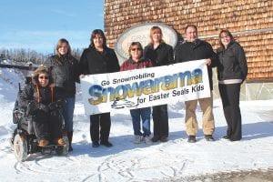 Planning for the 11th annual Snowarama for Easter Seals Kids in Grand Portage is under way and Easter Seals ambassador Zack Pylychuk made a visit to his friends at the Grand Portage Lodge & Casino on Tuesday, January 14. The event is truly international, with riders from Ontario and Minnesota gathering to ride the trails to benefit Easter Seals kids like Zack. (L-R) Easter Seal Ambassador Zack Pylychuk, Deb Owens of Grand Portage Lodge & Casino, Dana Logan of Grand Portage Trail Riders, MaryAnn Gagnon of Grand Portage Trail Riders, Billi Carlson of Grand Portage Lodge, Frank Vecchio of Grand Portage Lodge and Rhonda Harrison of Easter Seals Ontario. For more about the 2014 Snowarama, see page B4.