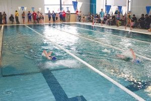 The Cook County YMCA hosted its first swim meet ever on Saturday, January 18 and the pool area was packed with spectators cheering on the kids from Cook County and their competitors from the Duluth YMCA. Enthusiasm was high and competition often close, like these backstrokers above who finished within a second of each other.