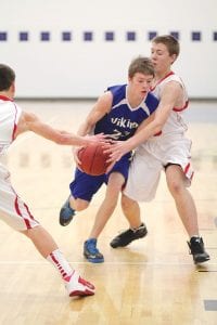 Above: Although it would appear that Owen Anderson was being fouled on this play, no whistles blew as he tried to get by a couple of Ely defenders. Left: Seth Warren showed nice form on this jump shot, but as the Vikings found all night long, any time they tried to shoot an Ely defender was in their face.